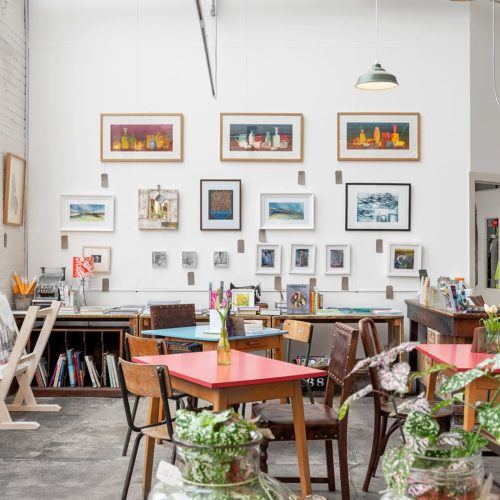 Tables and chairs with wall art at Sunny Bank Mills Yorkshire
