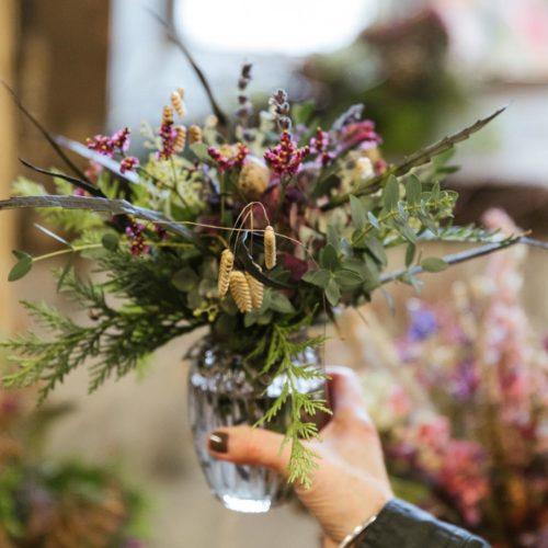 Holding vase with flowers inside