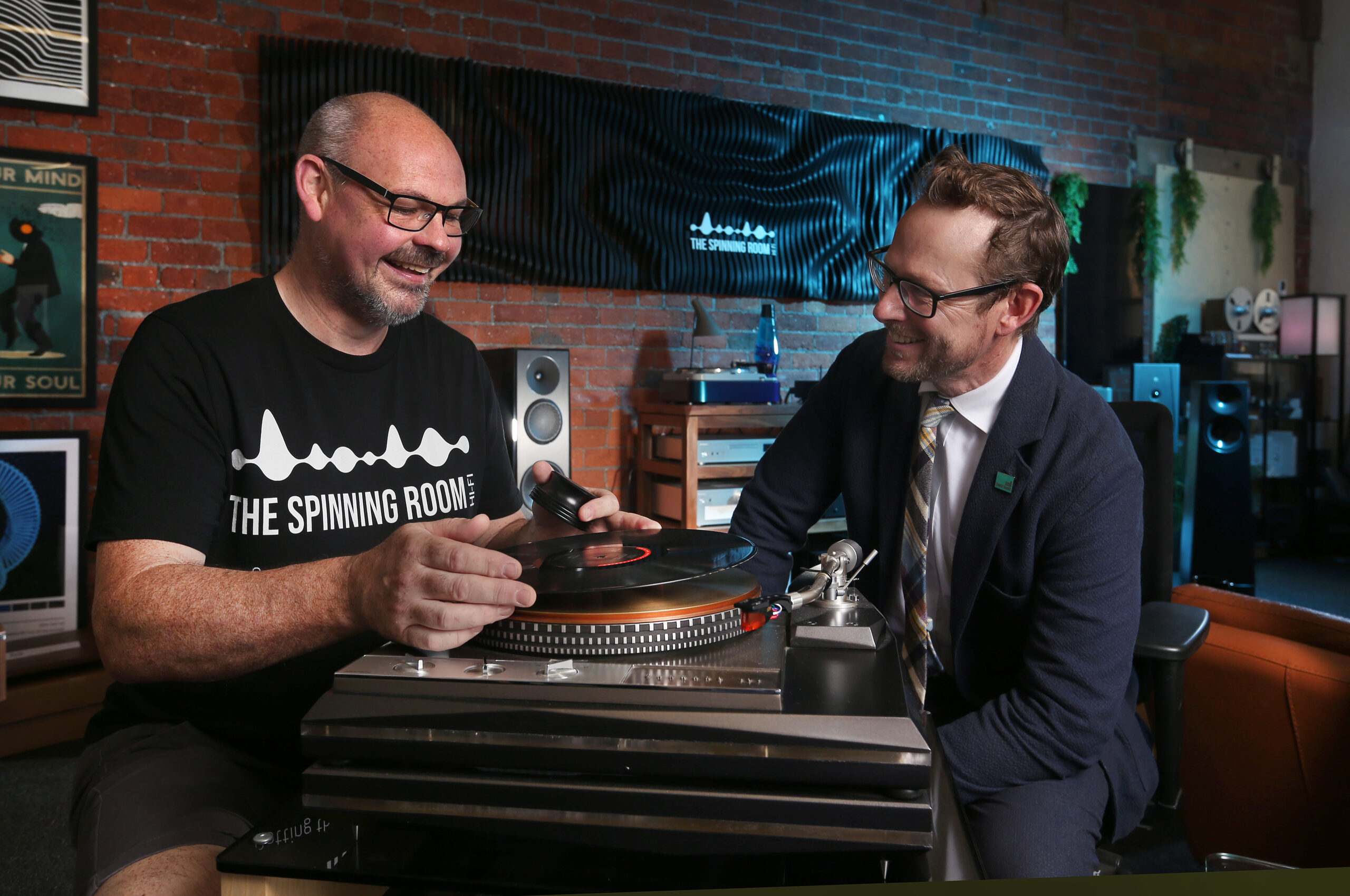 Paul Knipe and John Gaunt sitting side by side over Hi-Fi equipment